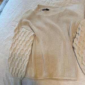 Elegant Beige Knit Sweater with Textured Sleeves